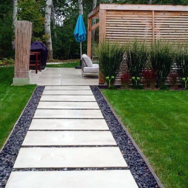 Modern paver walkway with large slab stones and black gravel border